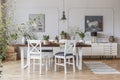 Real photo of a rustical dining room interior with a wooden table, chairs and plants Royalty Free Stock Photo