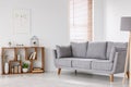 Real photo of a scandi living room interior with gray settee sta Royalty Free Stock Photo
