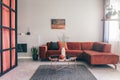 Simple, elegant living room interior with red furniture and an oil painting on white wall