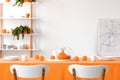 Real photo of two chairs placed by the table in white dining room Royalty Free Stock Photo