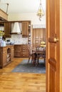 Real photo of a wooden kitchen interior with cupboards, dining t Royalty Free Stock Photo