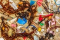 Real plastic pollution washed up on beach mixed with seaweed shells and feathers