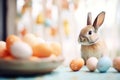 real rabbit beside pastelcolored easter eggs