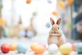 real rabbit beside pastelcolored easter eggs