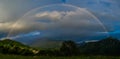 Real rainbow above a small village Royalty Free Stock Photo