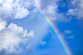 Real rainbow on blue sky with clouds nature background. Royalty Free Stock Photo