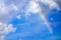 Real rainbow on blue sky with clouds nature background. Royalty Free Stock Photo