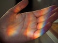 A real rainbow in the palm of your hand, as a symbol of LGBTQ. Concept: catch a rainbow with your hands, be real. Concepts of