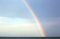 Real rainbow after the storm over the ocean and the blue sky