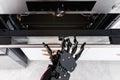 Real robot's hand and electric oven. Concept of robotic process automation