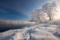 Real Russian Winter. Morning Frosty Winter Landscape With Dazzling White Snow, Hoarfrost River Bank With Traces And Blue Sky. Fog