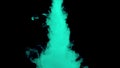 Real shot green paint drops in water. Ink swirling underwater. Cloud of ink collision isolated on black background