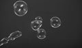 Real soap bubbles floating and moving on studio background