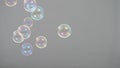 Real soap bubbles floating and moving on studio background