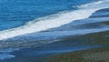 Multi-Colored Round Sea Pebble On Sea Coast. Wave Leaves White Marks. Real time. Royalty Free Stock Photo