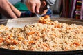 Real traditional street pilaf or plov, rice dish cooking in stock or broth