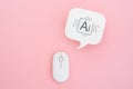 real white speech bubble paper cut with Ai icon and wireless computer mouse on pink background Royalty Free Stock Photo