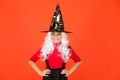 Real witch in disguise. Little child in witch costume. Halloween party. Small girl in black witch hat. Autumn holiday Royalty Free Stock Photo