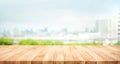 Real wood table top texture on blur leaf tree garden and wall building from city,park background Royalty Free Stock Photo