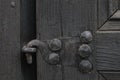 Real wooden texture with a hand-wrought iron element. Wood with iron background. A wooden door with an iron lock of old times. Old Royalty Free Stock Photo