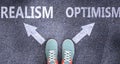 Realism and optimism as different choices in life - pictured as words Realism, optimism on a road to symbolize making decision and