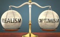 Realism and optimism staying in balance - pictured as a metal scale with weights and labels realism and optimism to symbolize