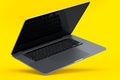 Realistic aluminum laptop with empty white screen isolated on yellow background. Royalty Free Stock Photo