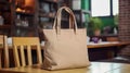 Realistic Beige Tote Canvas Fabric Bag Set-up In A Restaurant, Coffee Shop Interior, Tote Mock Up Blank. Beige Tote Bag Template