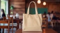 Realistic Beige Tote Canvas Fabric Bag Set-up In A Restaurant, Coffee Shop Interior, Tote Mock Up Blank. Beige Tote Bag Template