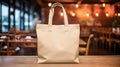 Realistic Beige Tote Canvas Fabric Bag Set-up In A Restaurant, Coffee Shop Interior, Tote Mock Up Blank. Beige Tote Bag Template