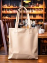 Realistic Beige Tote Canvas Fabric Bag Set-up In A Restaurant, Coffee Shop Interior, Tote Mock Up Blank. Beige Tote Bag Template