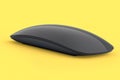 Realistic black wireless computer mouse with touch isolated on yellow background Royalty Free Stock Photo