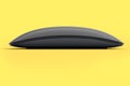 Realistic black wireless computer mouse with touch isolated on yellow background Royalty Free Stock Photo