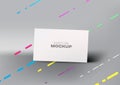 Realistic business card mockup template on modern gray background with colorful diagonal lines