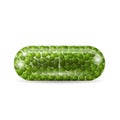 Realistic capsule pill with green granules inside it. Royalty Free Stock Photo