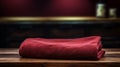 Realistic Chiaroscuro Photograph Of Maroon Towel On Wooden Table