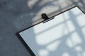 Realistic clipboard with blank paper sheet isolated on concrete background. 3d rendering