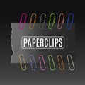 Realistic colorful paper clips on a dark background