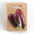 Realistic 3d eggplants on a cutting board.