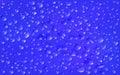 Realistic dark blue background, rectangular surface. Transparent droplets range of liquid lie on on motley backdrop. Clean water Royalty Free Stock Photo