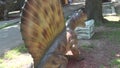 Realistic Dimetrodon dinosaur in park Behind the back