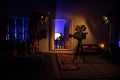 A realistic dollhouse living room with furniture and window at night. Artwork table decoration with handmade realistic dollhouse.