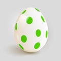 Realistic Easter egg with green spot pattern. Royalty Free Stock Photo