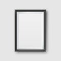 Realistic Empty Black Picture Frame Mockup. Realistic empty black picture frame, isolated on a neutral gray background. Royalty Free Stock Photo