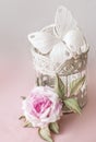 Realistic Fabric Silk flower in pink and white colors rose and butterfly hand made on decorative tracery cage. Retro style Gift fo Royalty Free Stock Photo