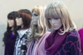 Realistic female mannequins stand in a row in the store