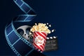 Realistic film stripe wave with popcorn box, film roll and clapper. Modern Cinema Background. 3d isometric film strip