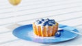 Realistic food. Mini tart with blueberries and cream filling on wooden table. 3D render