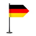 Realistic German table flag on a black steel pole. Souvenir from Germany. Desk flag made of paper or fabric and shiny