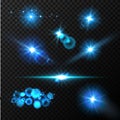 Realistic glow blue light effects. Lens flare set. Realistic glowing sparkles particles effects on dark transparent grid Royalty Free Stock Photo